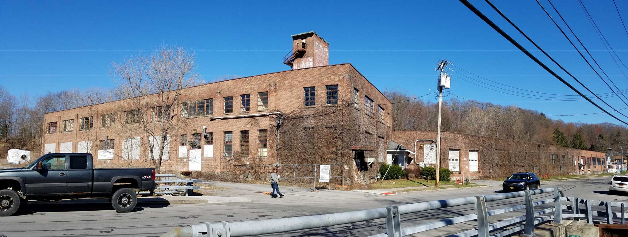 Photograph of the existing factory building on the Angelica brownfield redevelopment site. In urban planning, brownfield land is any previously developed land that is not currently in use that may be potentially contaminated. The term is also used to describe land previously used for industrial or commercial purposes with known or suspected pollution including soil contamination due to hazardous waste.