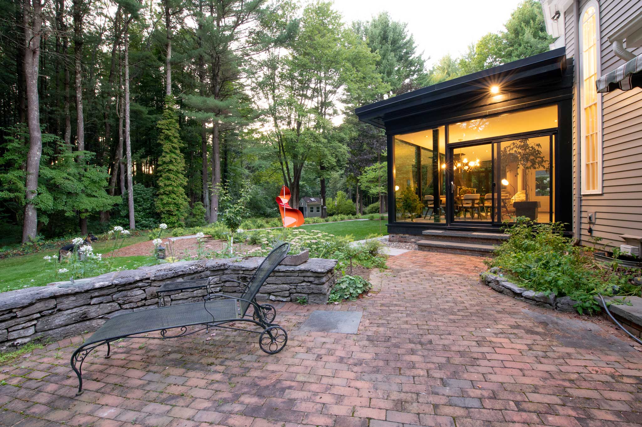 Exterior view of home addition showing side patio blending in with the home addition design.