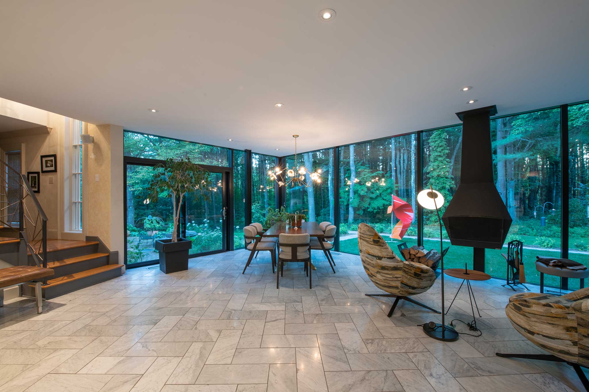 Interior view showing modern decor with the exterior view through the glass walls.